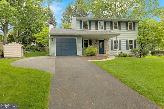 1995 Pierce Dr, Whitehall, PA 18052 - view of front of property with driveway, a garage, a front lawn, and a chimney
