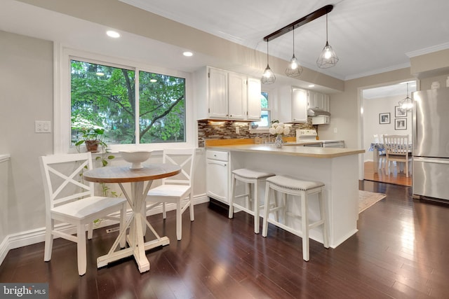 1995 Pierce Dr, Whitehall, PA 18052 - kitchen featuring freestanding refrigerator, ornamental molding, white electric range, white cabinets, and decorative backsplash