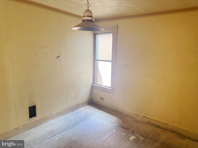1007 Appleton St, Baltimore, MD 21217 - empty room with plenty of natural light, ornamental molding, hardwood / wood-style flooring, a textured ceiling, and baseboards