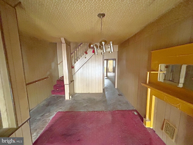 1007 Appleton St, Baltimore, MD 21217 - unfurnished dining area featuring a chandelier, stairs, and a textured ceiling