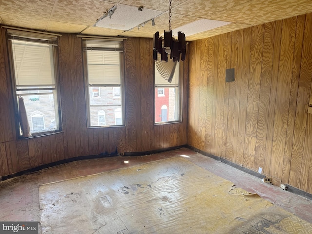 1007 Appleton St, Baltimore, MD 21217 - empty room with baseboards, a chandelier, and wooden walls