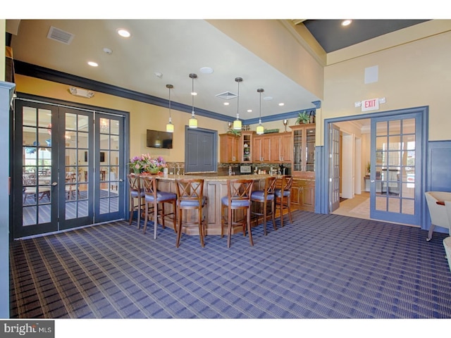 30 Keswick Path, Medford, NJ 08055 - kitchen with french doors, carpet flooring, brown cabinets, a kitchen breakfast bar, and glass insert cabinets