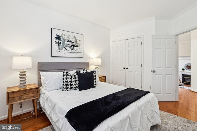 4691 Longstreet Ln Unit 202, Alexandria, VA 22311 - bedroom featuring wood finished floors, crown molding, a closet, and baseboards