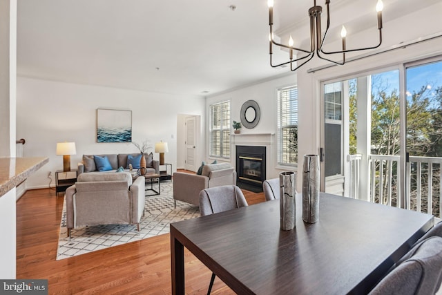 4691 Longstreet Ln Unit 202, Alexandria, VA 22311 - dining space with wood finished floors, a glass covered fireplace, and a chandelier