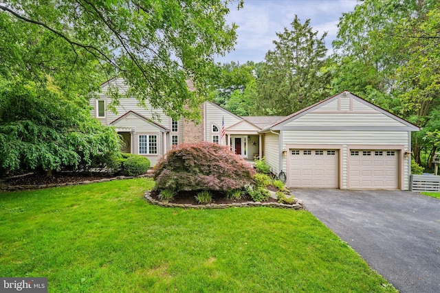 114 W Pembrey Dr, Wilmington, DE 19803 - view of front of house with asphalt driveway, an attached garage, and a front yard