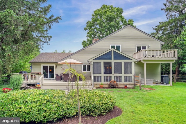 114 W Pembrey Dr, Wilmington, DE 19803 - back of property with a chimney, a deck, and a sunroom