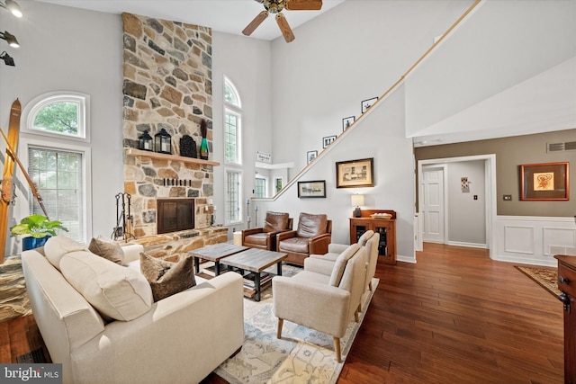 114 W Pembrey Dr, Wilmington, DE 19803 - living area with a towering ceiling, healthy amount of natural light, a stone fireplace, hardwood / wood-style floors, and a ceiling fan