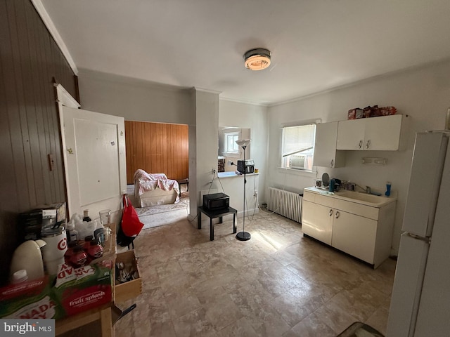 2905 Echodale Ave, Baltimore, MD 21214 - kitchen with radiator, freestanding refrigerator, a sink, ornamental molding, and light countertops