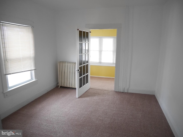 2905 Echodale Ave, Baltimore, MD 21214 - empty room featuring radiator, healthy amount of natural light, carpet floors, and french doors