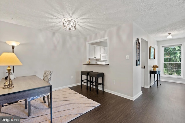 10161 Oakton Terrace Rd, Oakton, VA 22124 - office featuring a textured ceiling, wood finished floors, baseboards, and a chandelier