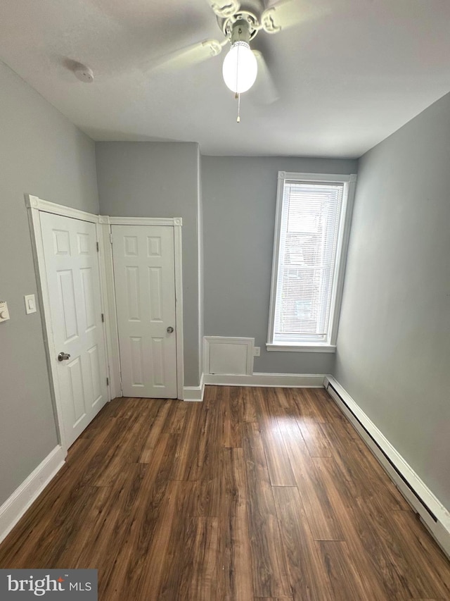 4549 N Mole St, Philadelphia, PA 19140 - unfurnished bedroom with a baseboard radiator, dark wood-style floors, baseboards, and ceiling fan