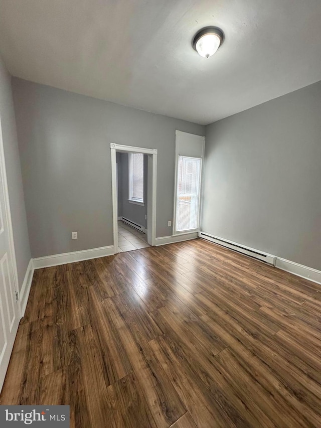 4549 N Mole St, Philadelphia, PA 19140 - spare room with a baseboard radiator, wood finished floors, and baseboards