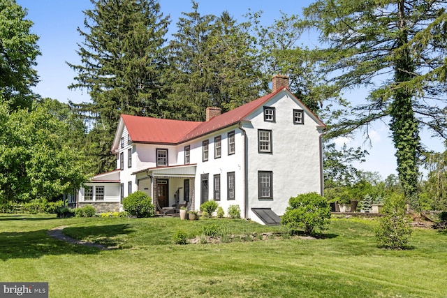 408 Kintner Hill Rd, Upper Black Eddy, PA 18972 - view of front of house featuring a chimney, a front lawn, metal roof, and stucco siding