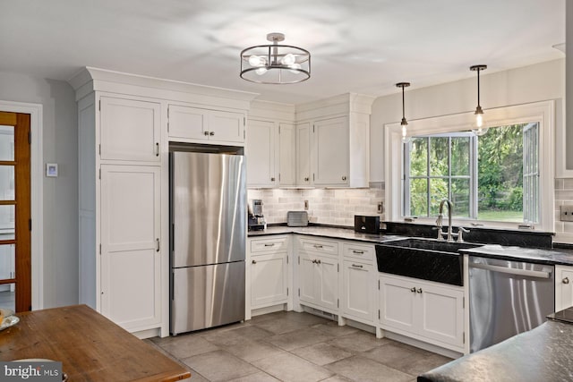408 Kintner Hill Rd, Upper Black Eddy, PA 18972 - kitchen with appliances with stainless steel finishes, dark countertops, a sink, decorative backsplash, and white cabinets