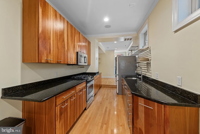 3006 Dillon St, Baltimore, MD 21224 - kitchen with appliances with stainless steel finishes, brown cabinets, a sink, light wood-style flooring, and ornamental molding
