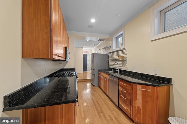 3006 Dillon St, Baltimore, MD 21224 - kitchen featuring stainless steel appliances, brown cabinetry, a sink, crown molding, and light wood-style floors