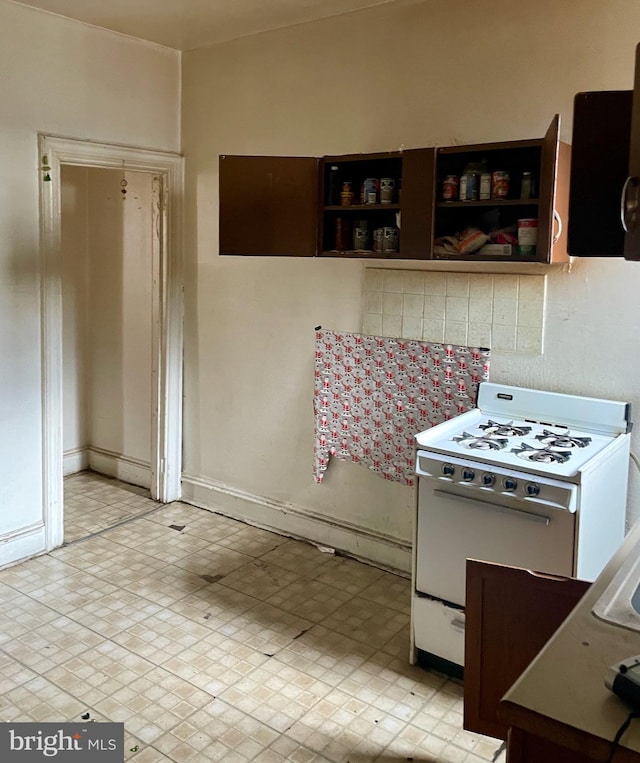 542 W Tioga St, Philadelphia, PA 19140 - kitchen with white gas range oven, baseboards, and open shelves