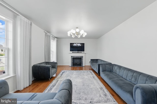 19102 Black Maple Way, Hagerstown, MD 21742 - living room with plenty of natural light, a premium fireplace, wood finished floors, and a chandelier