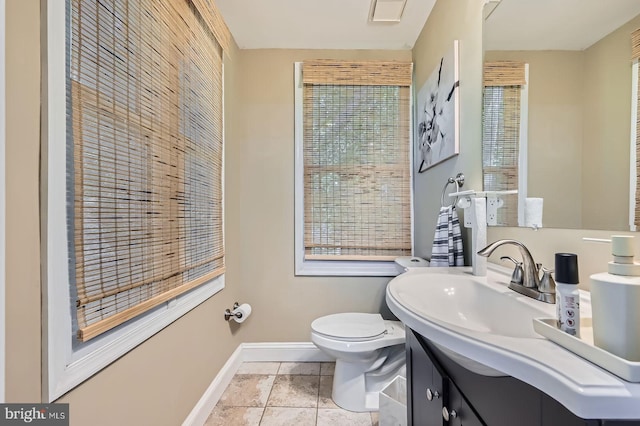 3203 Beverly Rd, Baltimore, MD 21214 - bathroom with baseboards, toilet, vanity, and healthy amount of natural light