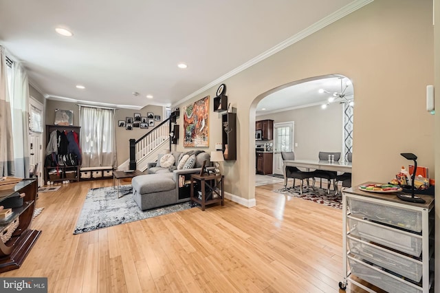 3203 Beverly Rd, Baltimore, MD 21214 - living area with arched walkways, ornamental molding, stairway, light wood-style flooring, and baseboards