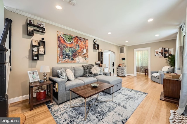 3203 Beverly Rd, Baltimore, MD 21214 - living area featuring arched walkways, ornamental molding, light wood finished floors, baseboards, and recessed lighting
