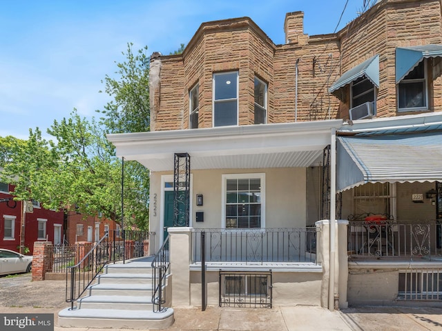 2223 W Indiana Ave, Philadelphia, PA 19132 - view of property with covered porch, stucco siding, and stone siding