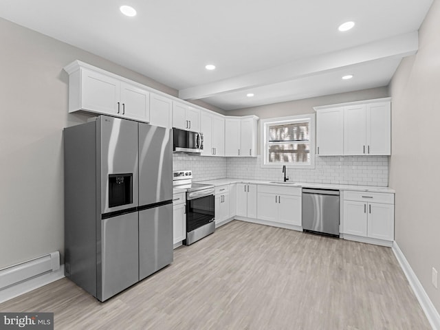 2223 W Indiana Ave, Philadelphia, PA 19132 - kitchen featuring appliances with stainless steel finishes, a sink, light countertops, light wood finished floors, and recessed lighting