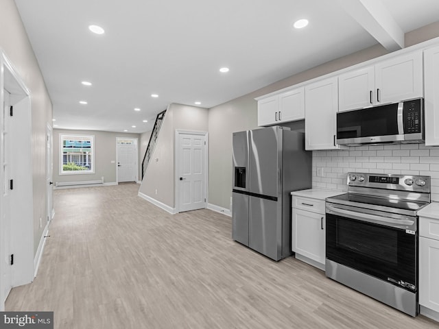 2223 W Indiana Ave, Philadelphia, PA 19132 - kitchen with stainless steel appliances, light countertops, light wood finished floors, white cabinetry, and recessed lighting