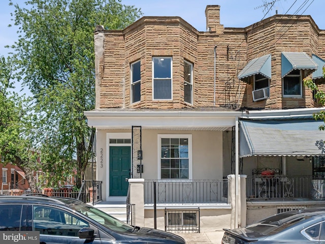 2223 W Indiana Ave, Philadelphia, PA 19132 - townhome / multi-family property featuring covered porch, stucco siding, and cooling unit