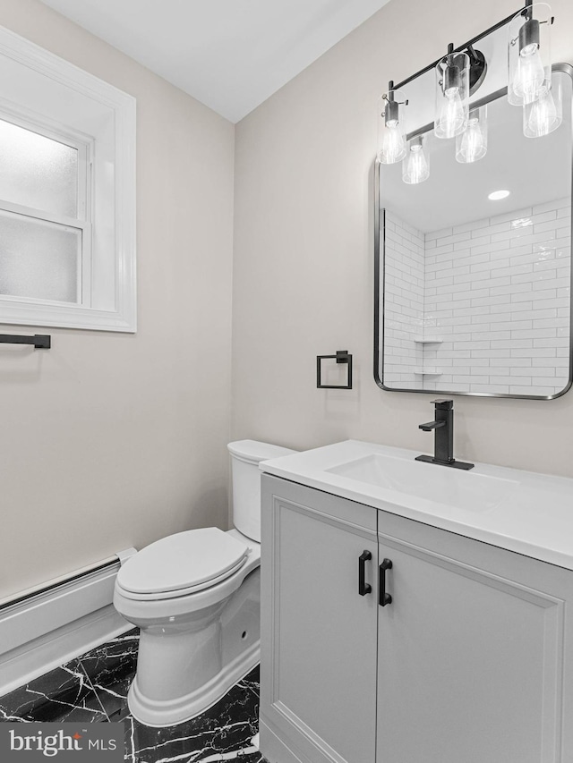 2223 W Indiana Ave, Philadelphia, PA 19132 - half bathroom with marble finish flooring, toilet, vanity, and a baseboard heating unit
