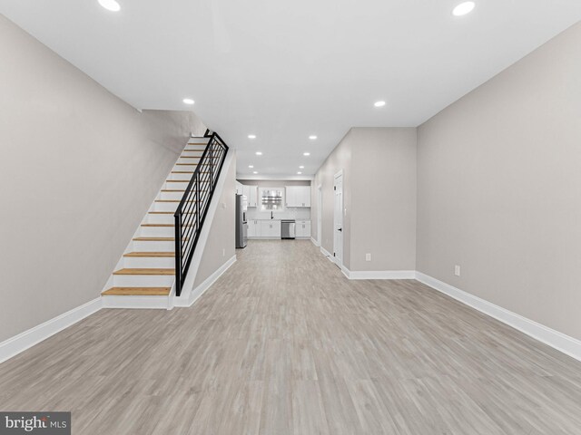 2223 W Indiana Ave, Philadelphia, PA 19132 - unfurnished living room featuring baseboards, recessed lighting, stairway, and light wood-type flooring