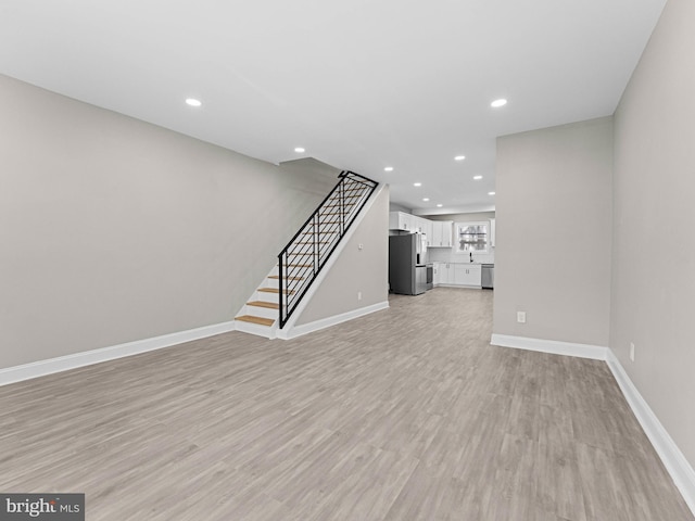 2223 W Indiana Ave, Philadelphia, PA 19132 - unfurnished living room featuring recessed lighting, light wood finished floors, stairway, and baseboards