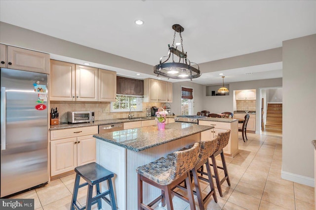 1 Birchall Dr, Haddonfield, NJ 08033 - kitchen featuring stainless steel appliances, a peninsula, a sink, light tile patterned flooring, and decorative backsplash