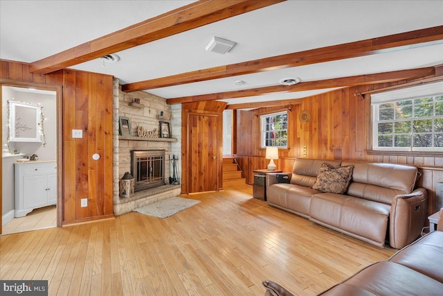 1 Birchall Dr, Haddonfield, NJ 08033 - living room featuring wood walls, light wood-style floors, beamed ceiling, healthy amount of natural light, and a stone fireplace