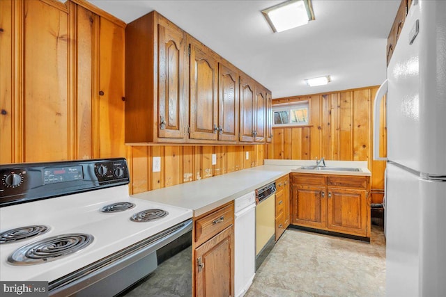 1 Birchall Dr, Haddonfield, NJ 08033 - kitchen with electric range, freestanding refrigerator, brown cabinetry, a sink, and wooden walls