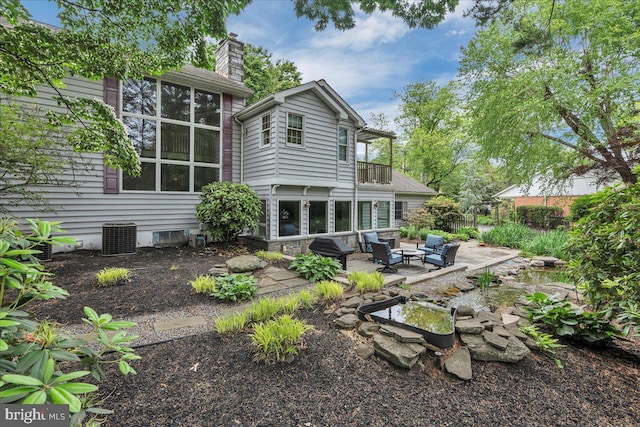 1 Birchall Dr, Haddonfield, NJ 08033 - back of property with a patio, a balcony, a chimney, an outdoor hangout area, and central AC
