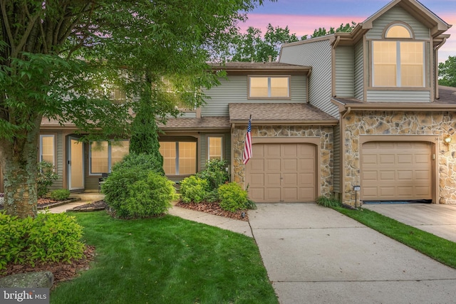 36 Kettlebrook Dr, Mount Laurel, NJ 08054 - townhome / multi-family property with driveway, stone siding, a garage, a yard, and a shingled roof
