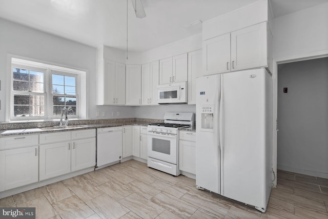6901 Park Heights Ave, Baltimore, MD 21215 - kitchen featuring white appliances, a sink, white cabinetry, and stone countertops