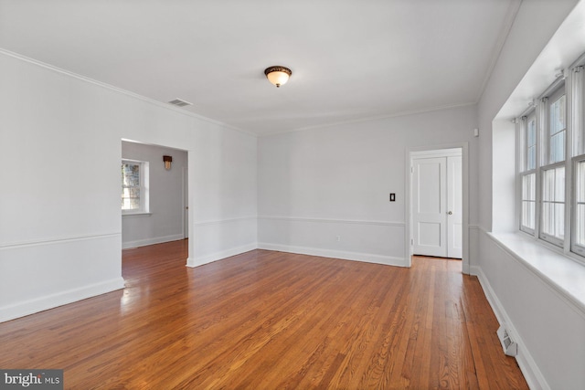 6901 Park Heights Ave, Baltimore, MD 21215 - unfurnished room with plenty of natural light, wood finished floors, crown molding, and baseboards
