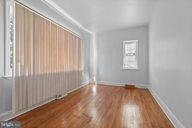 6901 Park Heights Ave, Baltimore, MD 21215 - spare room with wood-type flooring and baseboards