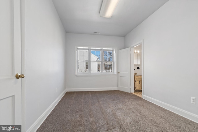 6901 Park Heights Ave, Baltimore, MD 21215 - unfurnished bedroom featuring carpet floors, baseboards, and ensuite bath