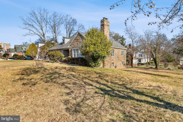 6901 Park Heights Ave, Baltimore, MD 21215 - view of side of home featuring a chimney and a lawn