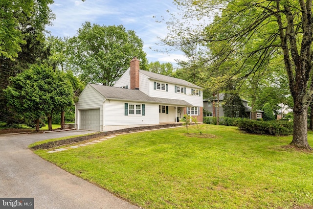 713 Red Maple Dr, West Chester, PA 19380 - view of front of property with driveway, a chimney, a front lawn, and an attached garage