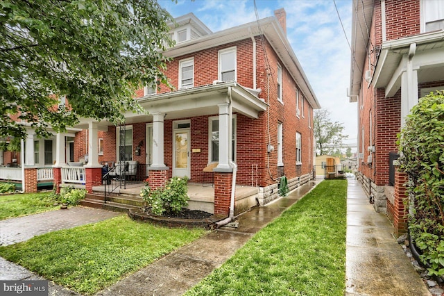 936 Hummel Ave, Lemoyne, PA 17043 - american foursquare style home with brick siding, a porch, and a front lawn