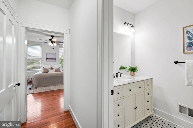 511 S E Ave, Baltimore, MD 21224 - ensuite bathroom with vanity, baseboards, ceiling fan, and wood finished floors