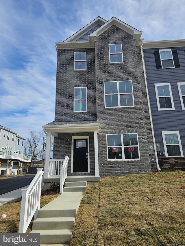7308 Roxy Run Unit 10, Clinton, MD 20735 - view of front of home with a front yard, brick siding, and a porch