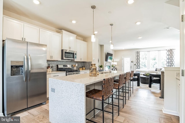 7308 Roxy Run Unit 10, Clinton, MD 20735 - kitchen with appliances with stainless steel finishes, a sink, an island with sink, white cabinets, and tasteful backsplash