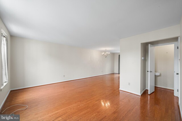 229 Bloomingdale Ave Unit 1, Wayne, PA 19087 - unfurnished room with a chandelier, wood finished floors, and baseboards