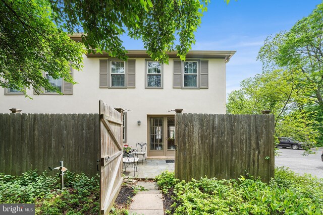 229 Bloomingdale Ave Unit 1, Wayne, PA 19087 - rear view of property with stucco siding and a patio