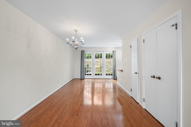 229 Bloomingdale Ave Unit 1, Wayne, PA 19087 - unfurnished room featuring a chandelier, wood finished floors, and baseboards